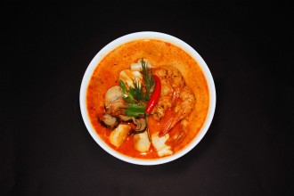 Classic Thai soup "Tom Yam" with tender king prawns