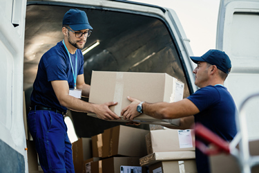 delivery men loading carboard boxes van while getting ready shipment1
