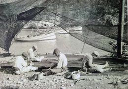 fishermen repairing nets