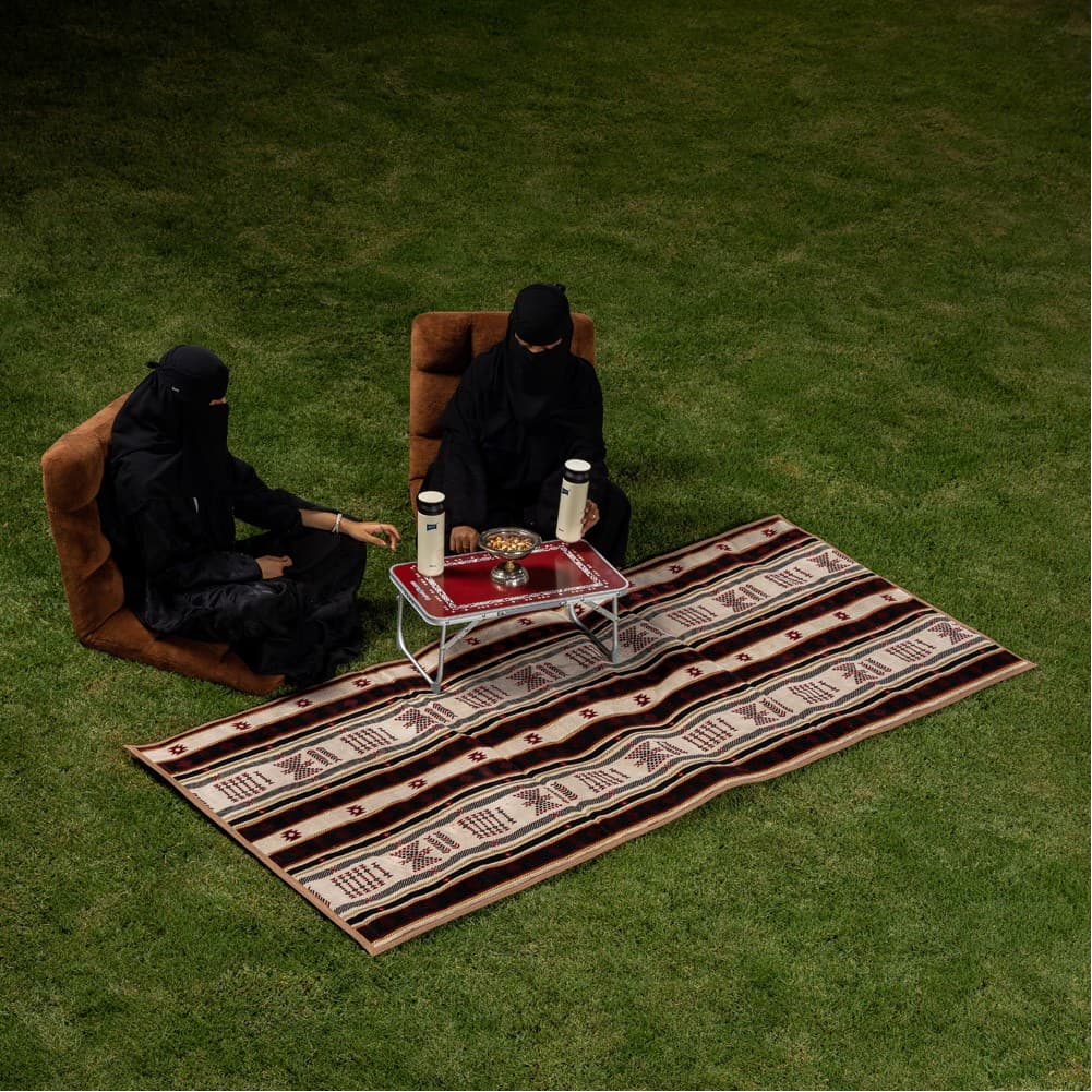 Alsanidi, a floor seating mat for trips, camping, and desert outings, padded with sponge, traditional rug, wooden *oudi.