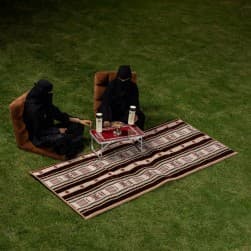 Alsanidi, a floor seating mat for trips, camping, and desert outings, padded with sponge, traditional rug, wooden *oudi.