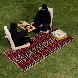 Alsanidi, a floor seating mat for trips, camping, and desert outings, padded with sponge, traditional rug, wooden *oudi.