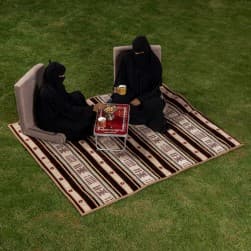 Alsanidi, a floor seating mat for trips, camping, and desert outings, padded with sponge, traditional rug, wooden *oudi.