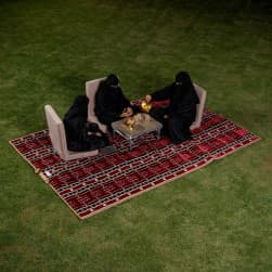 Alsanidi, a floor seating mat for trips, camping, and desert outings, padded with sponge, traditional rug, wooden *oudi.