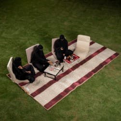 Alsanidi, a floor seating mat for trips, camping, and desert outings, padded with sponge, traditional rug, wooden *oudi.