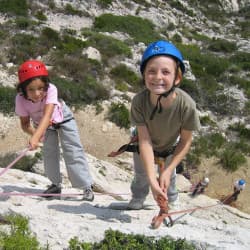 Enfant heureux d'avoir gravit la paroi d'escalade